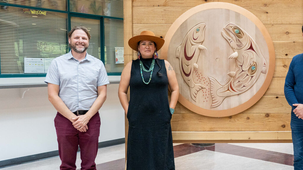 Houle staff standing with Indigenous Artist Crystal Sparrow at the presentation fo the commissioned spindle whorl for the Magee Secondary School Musqueum Legacy Project.