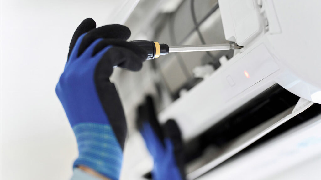 Technician or electrician fixing an AC